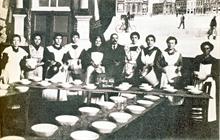 Wasmul : Sous l'occupation. Repas organis en faveur des enfants durant l'occupation. Bien que le rideau reproduise la Grand-Place de Saint-Ghislain, nous sommes ici  Wasmul (entre 1914 et 1918)